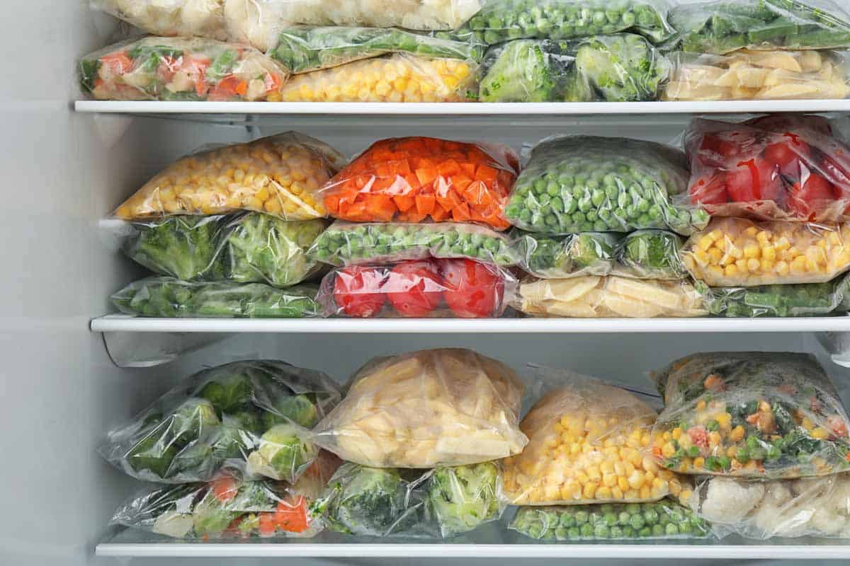 Bags of frozen vegetables in a freezer