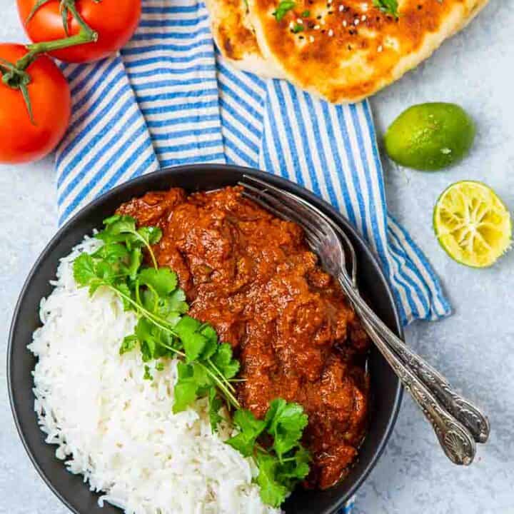 Overhead view of beef madras and white rice and naan