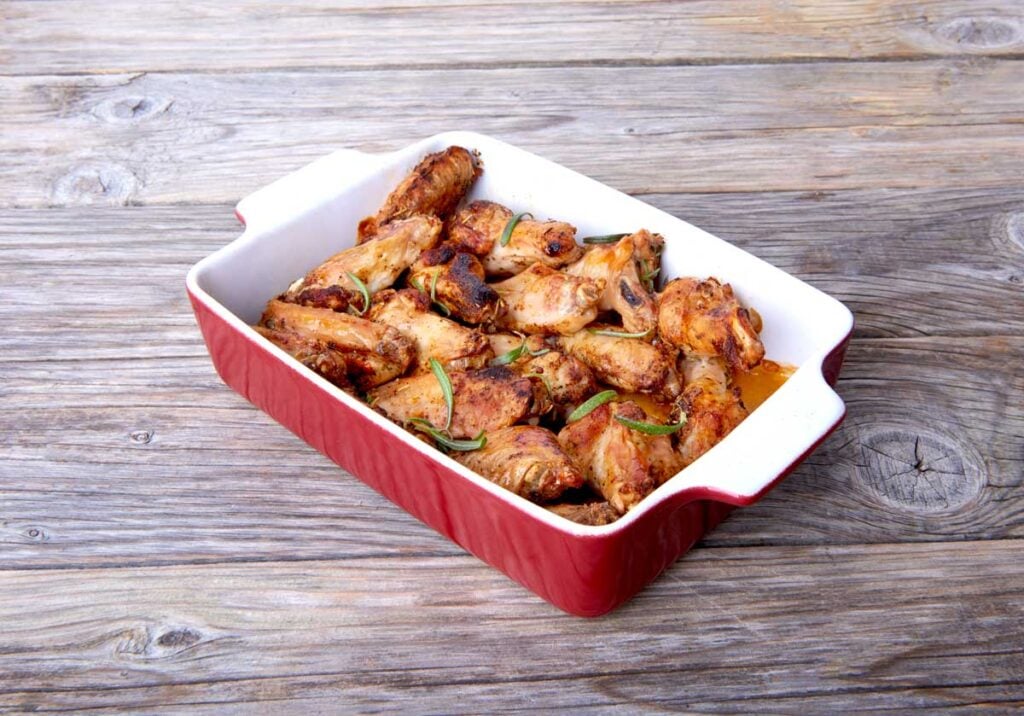 Chicken wings in bbq sauce in a casserole dish