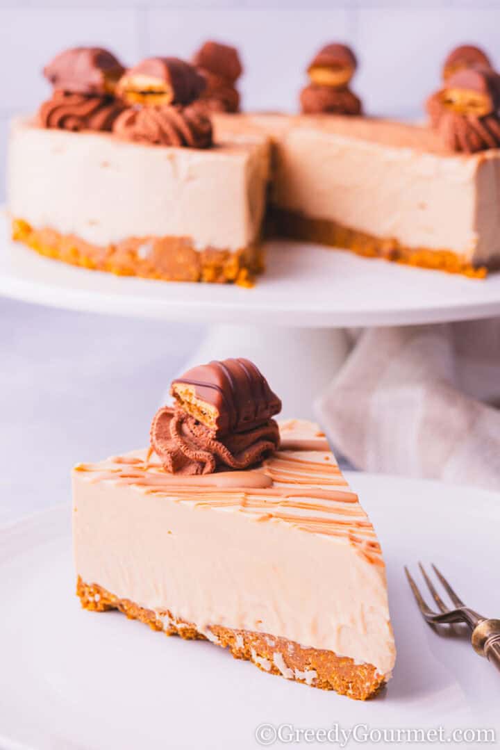 Kinder Bueno Cheesecake slice topped with  melted chocolate.