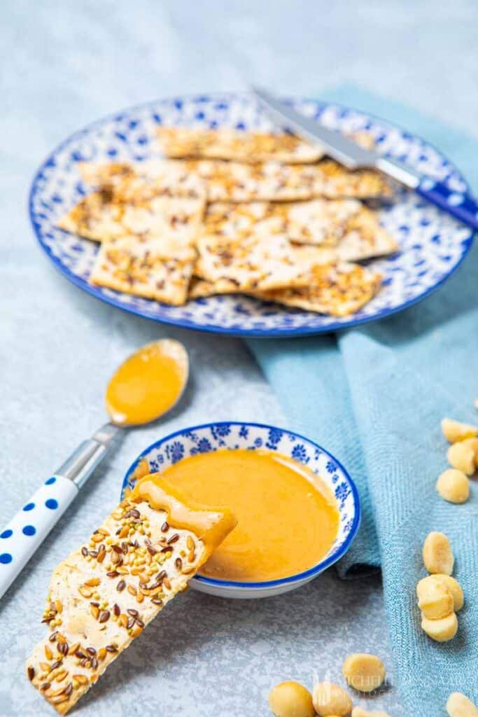 Bowl of yellow Macadamia butter with crackers