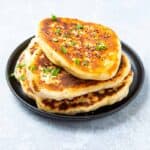 Plate of pan fried naan bread.