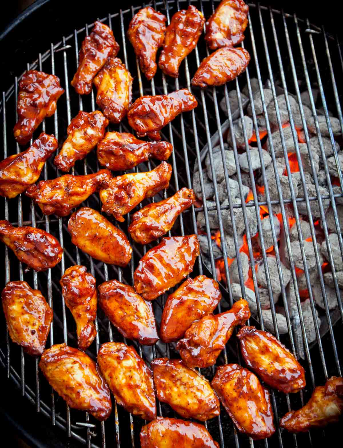 Chicken wings smothered in sauce on a bbq grill
