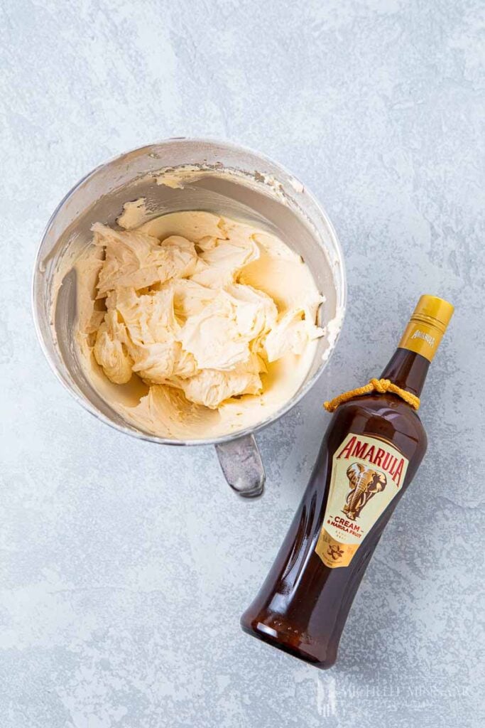 Bowl of buttercream and a bottle of Amarula