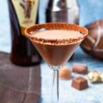 Martini glass rimmed with chocolate sugar and liquid amarula inside