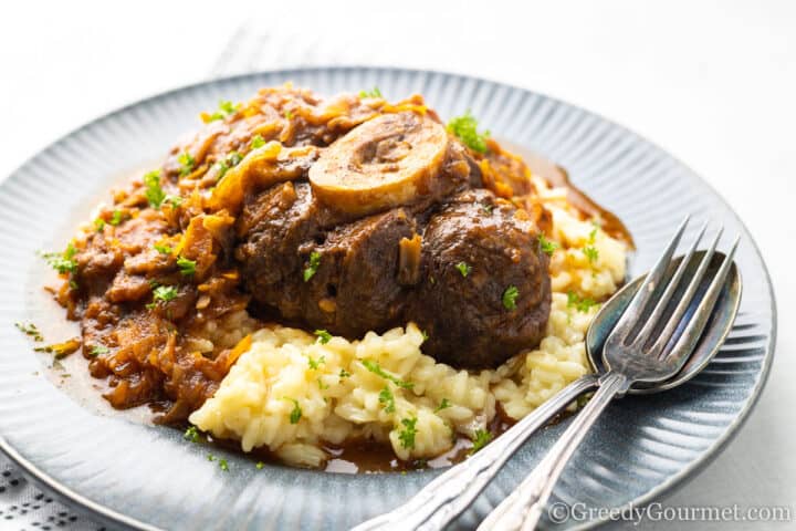 serving of Osso Buco on a blue plate.