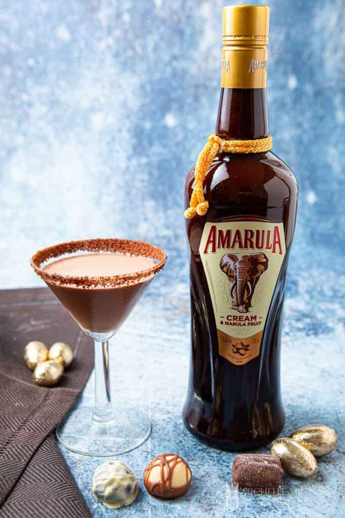 Glass of chocolate amarula cocktail and a bottle of amarula