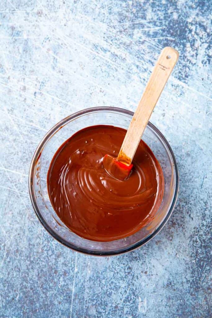 Chocolate ganache being mixed in a bowl