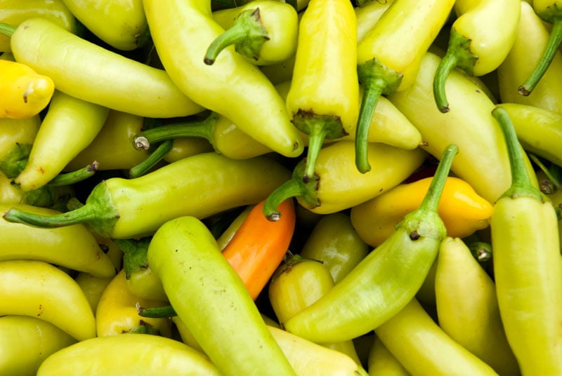 Pile of green banana peppers