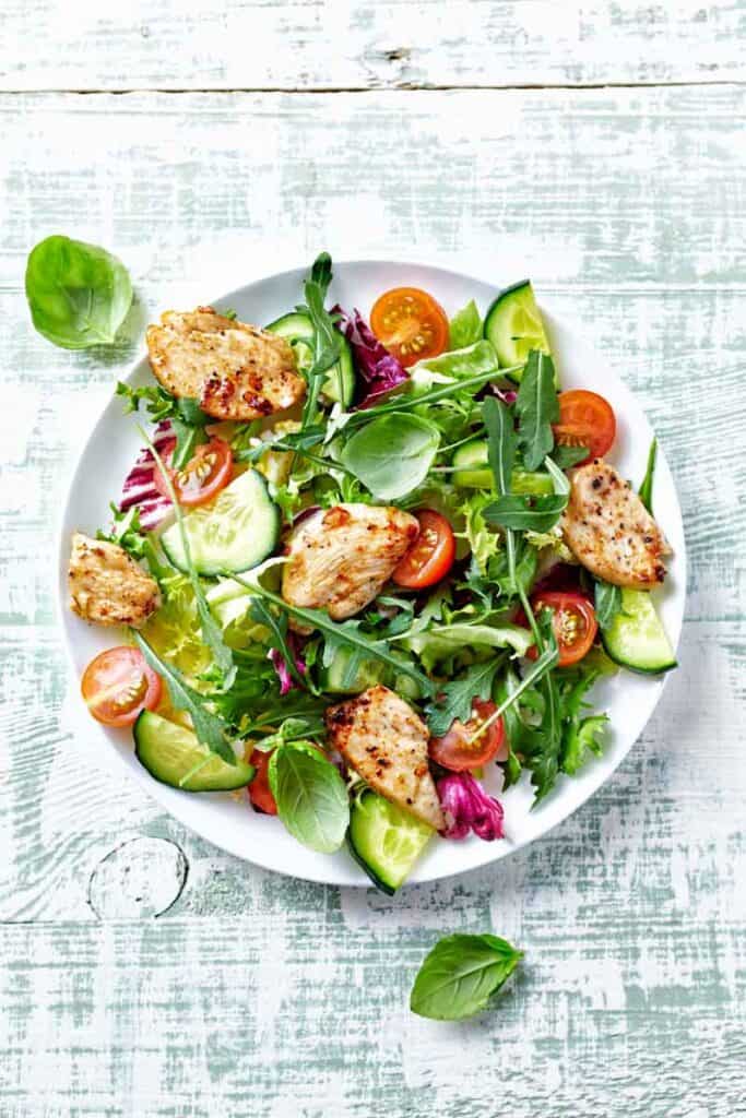 Round plate of chicken salad on a bed of lettuce