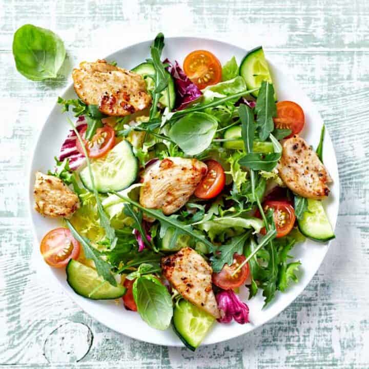 Round plate of chicken salad on a bed of lettuce