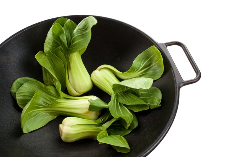 Green bok choy in a saute pan