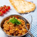 Bowl of brinjal bhaji and naan bread