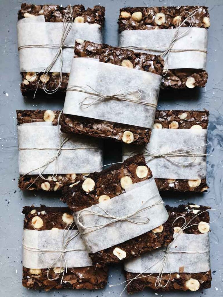 Chocolate brownies wrapped in paper to show how you can freeze brownies