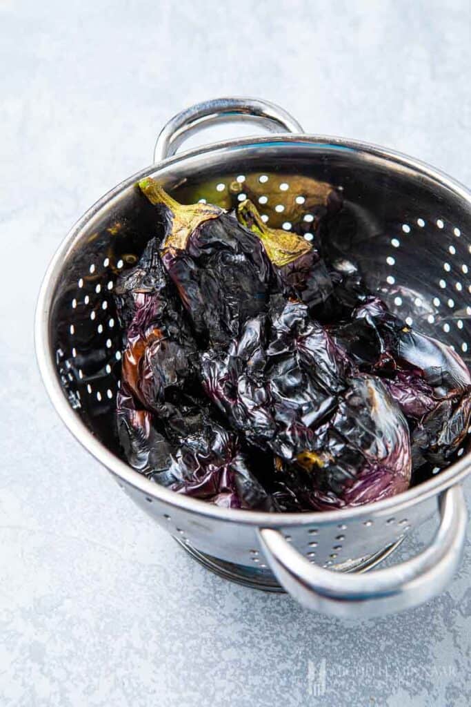 Grilled eggplant in a strainer