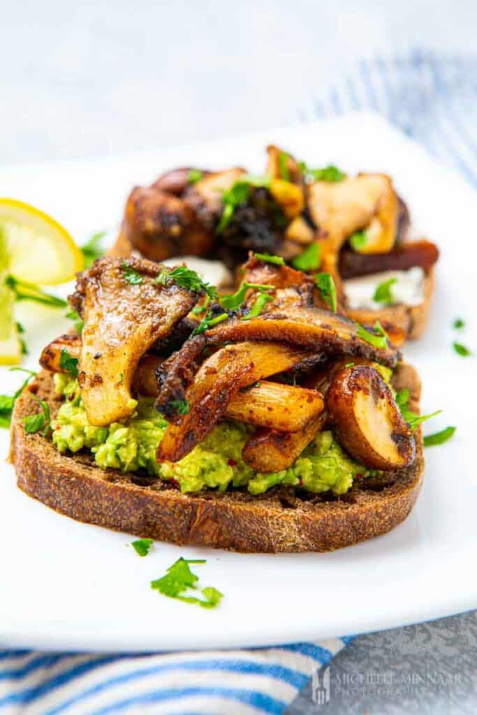 Close up of mushrooms piled high on taost 