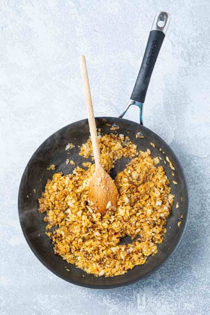 Onions and curry being made in a saucepan