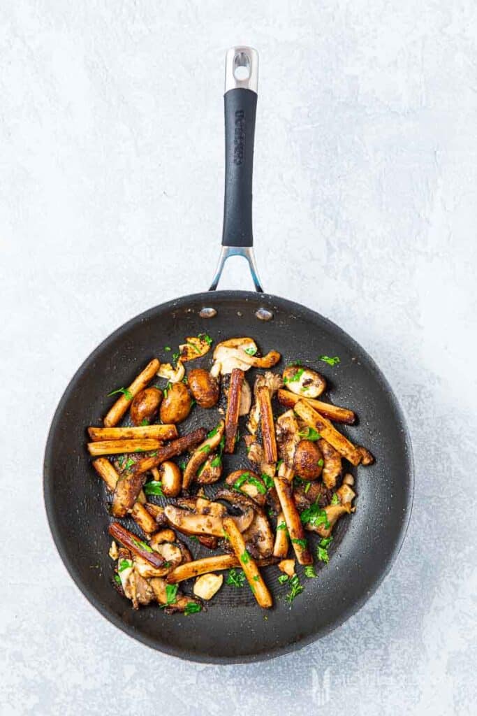 Mushrooms sauteing in a pan 