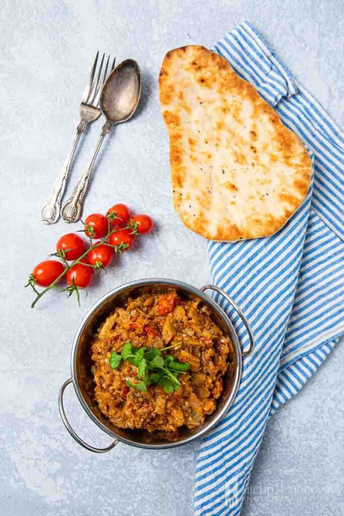 Bowl of brinjal bhaji and naan