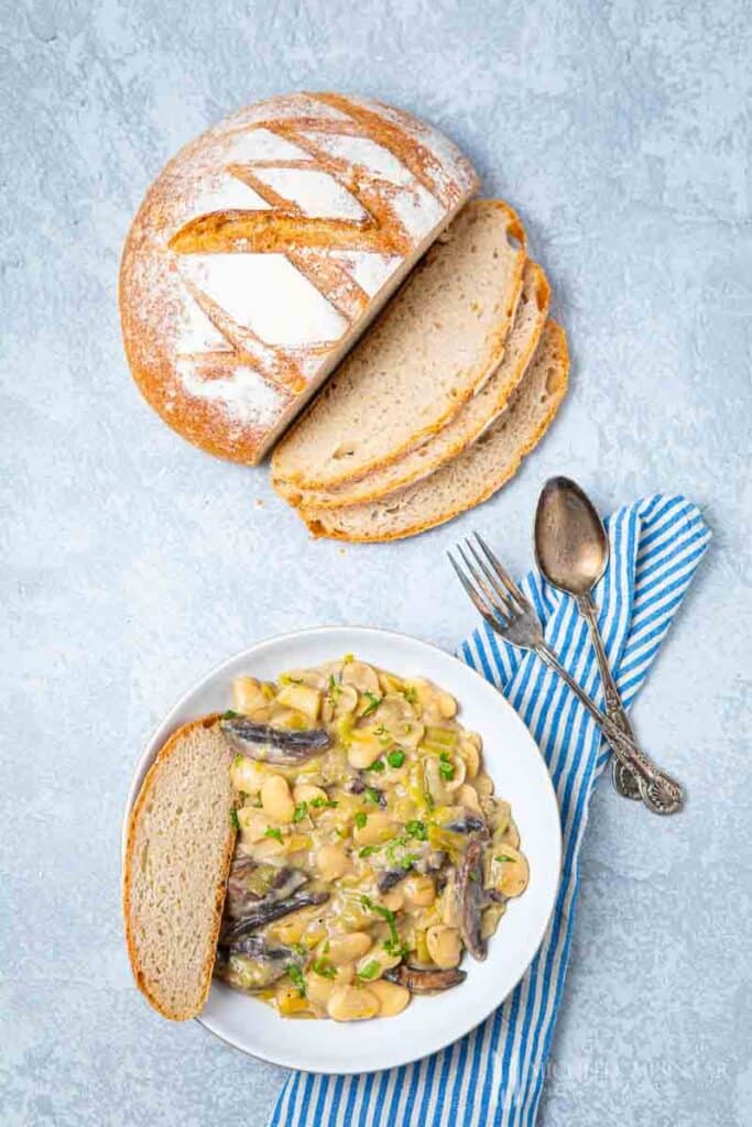 Bowl of butter bean stew and a side of bread 