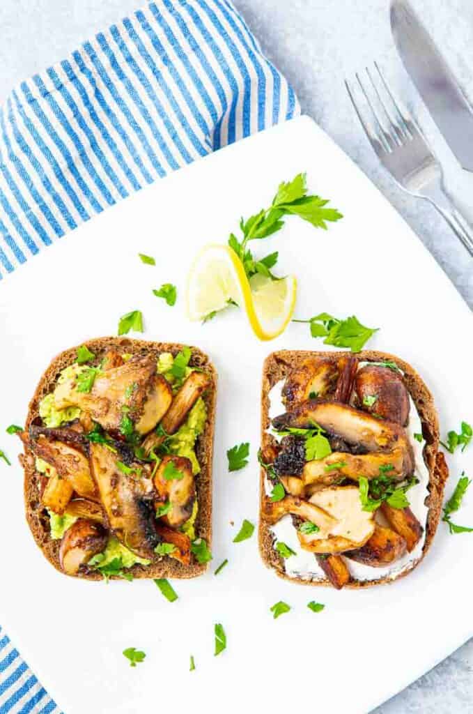 Aerial view of mushrooms on toast on white plate 