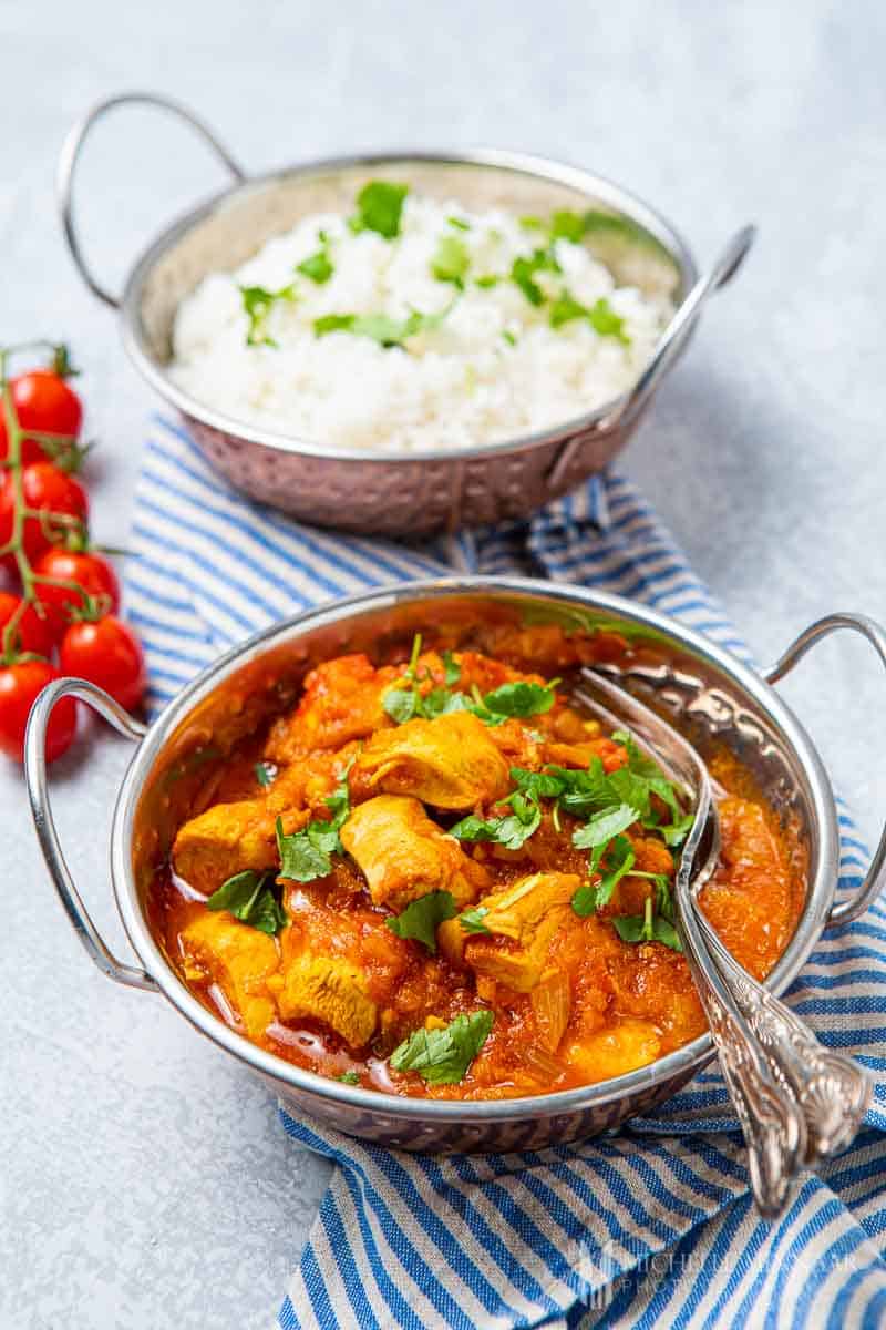 Bowl of chicken pathia and naan bread