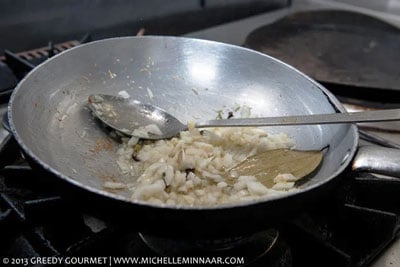 Onions and Bay leaf being added to the pan