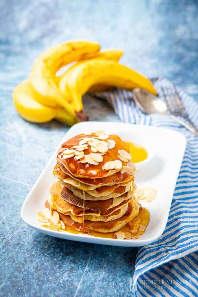 piled high pancakes with bananas