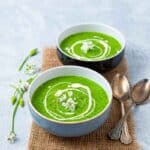 Two bowls of green wild garlic soup