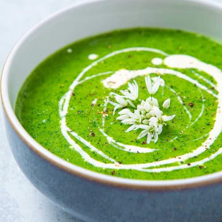 Green soup with white cream