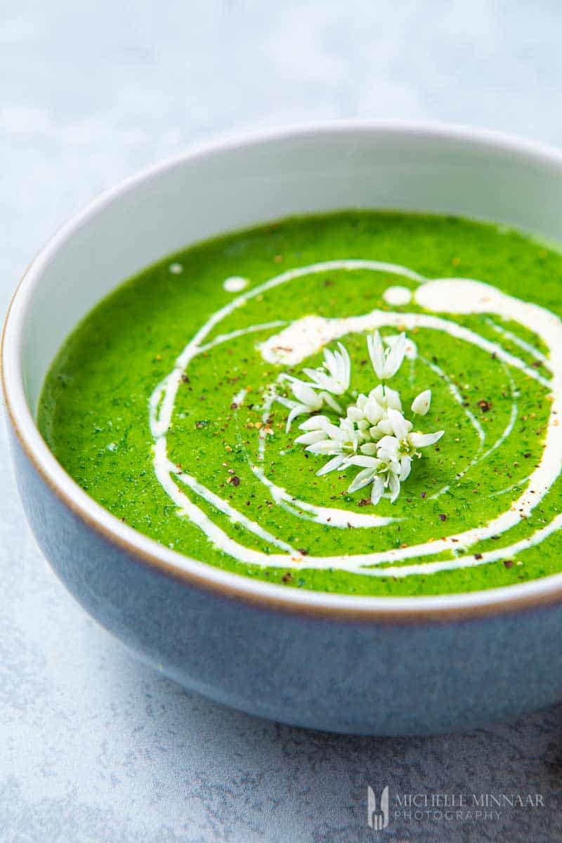 Green soup with white cream