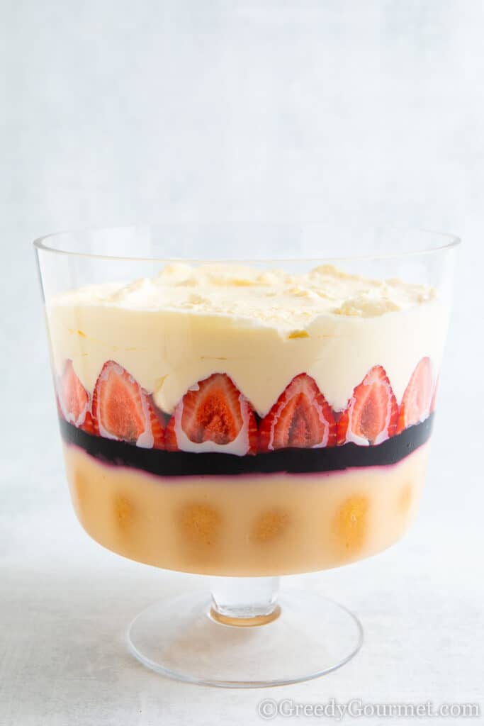 Four layers of a Amarula Berry Trifle in a clear trifle bowl