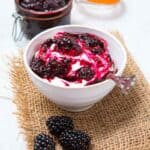 a bowl of fruit compote and blackberries