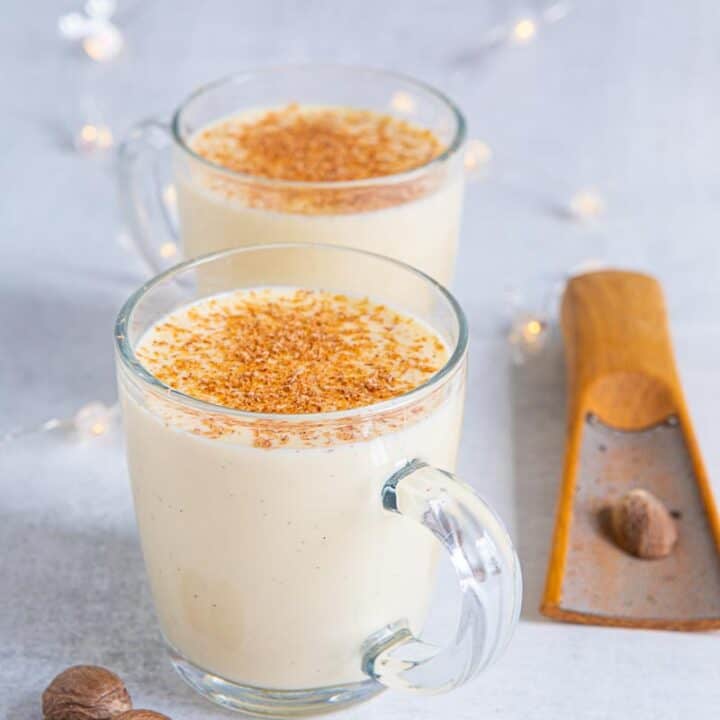 Two glass mugs of boiled custard with nutmeg