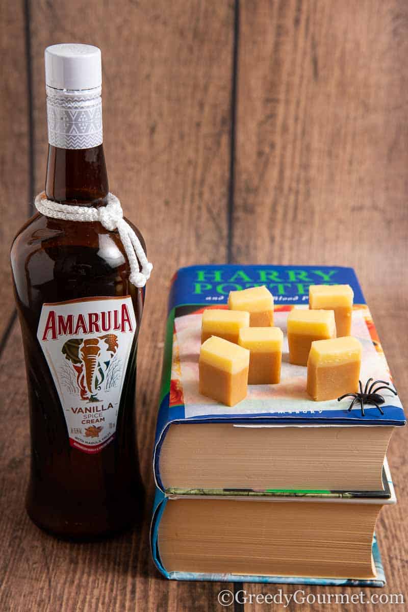 Bottle of Amarula and chunks of alcoholic fudge on Happy Potter books