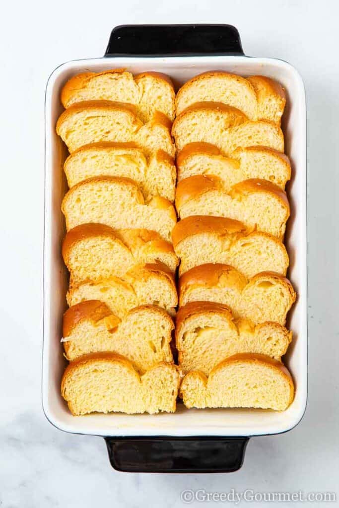 Bread lined up in a casserole dish