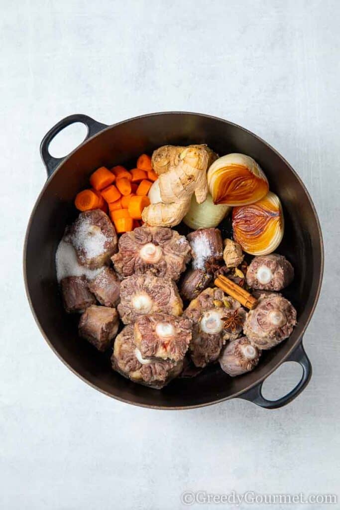 Oxtails braising with ginger, onions and carrots