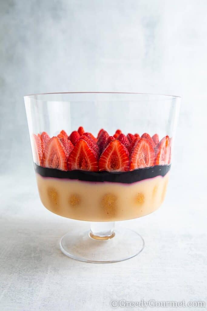Strawberries added to a Amarula Berry Trifle