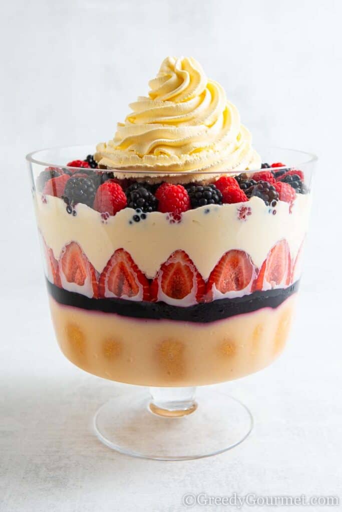 Completed Amarula Berry Trifle with a large sworl of whipped cream