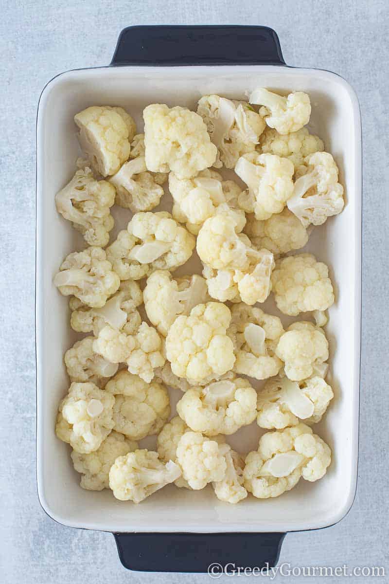 Raw cauliflower in a baking pan