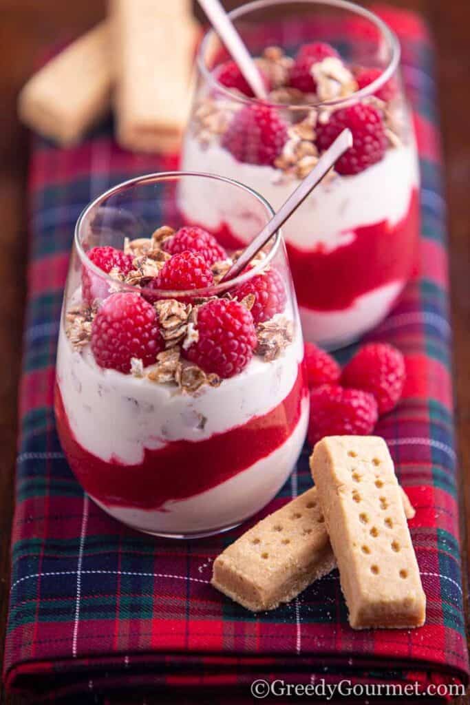 Two clear glasses of colourful Cranachan