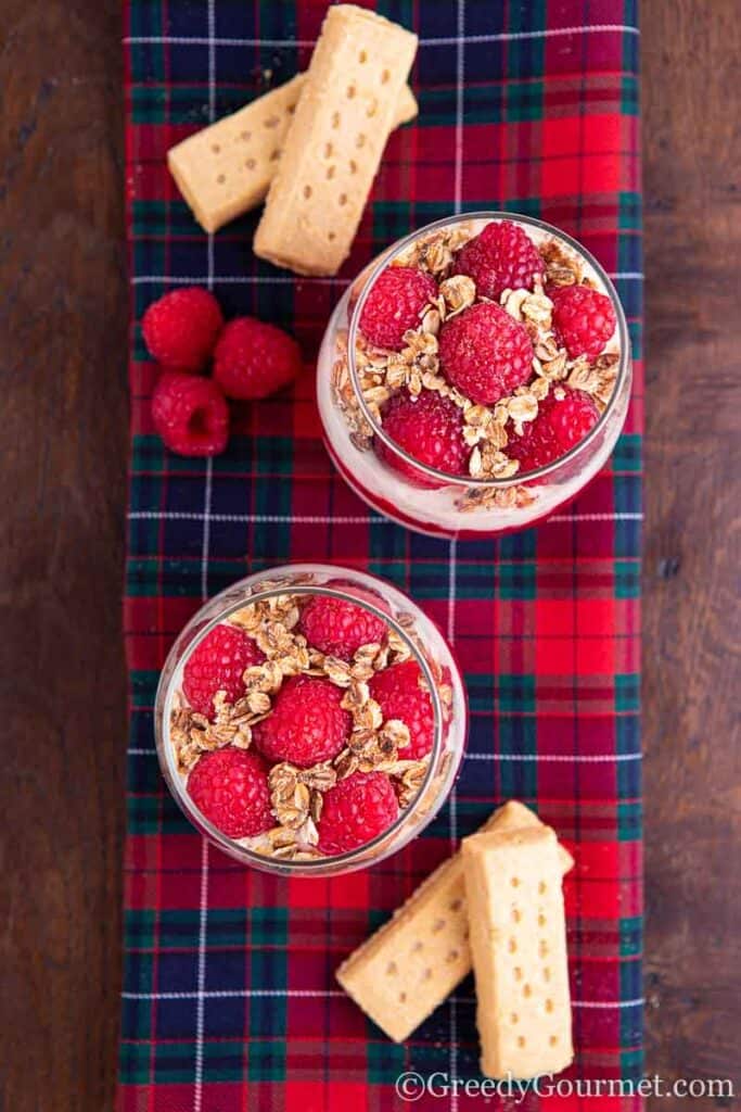 Two glasses of Scottish delicacies topped with raspberries