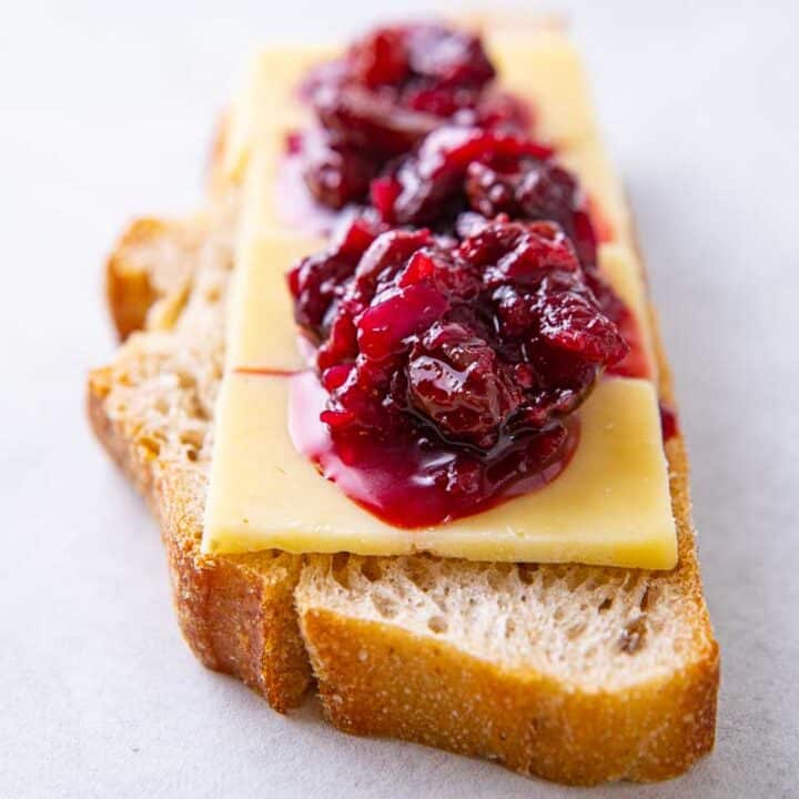 Close up up damson chutney on bread with cheese