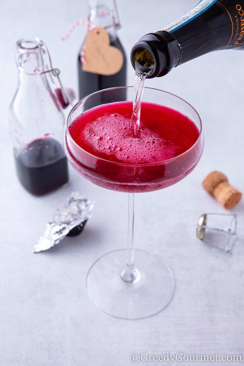 Gin being poured into a champagne glass