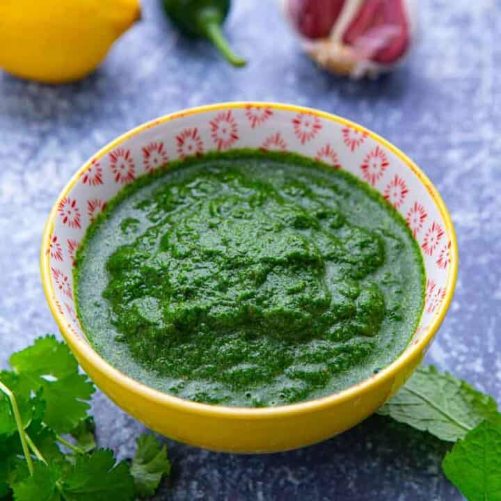 Bowl of bright green Indian sauce