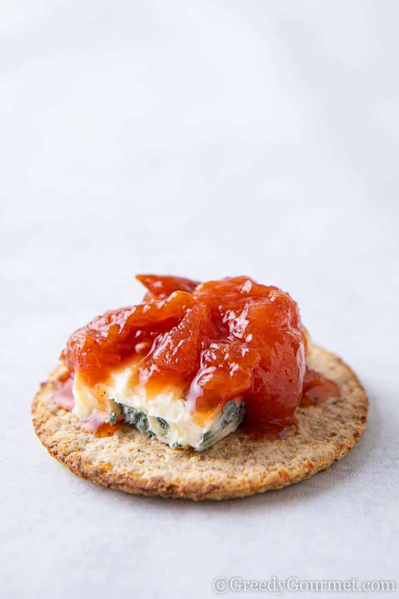 Cracker topped with blue cheese and a spiced plum chutney