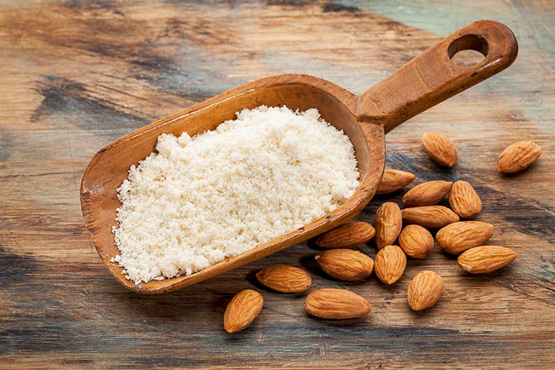 Almond flour in a wooden spoon