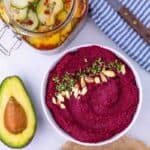 Bowl of a purple roasted beet recipe with an avocado