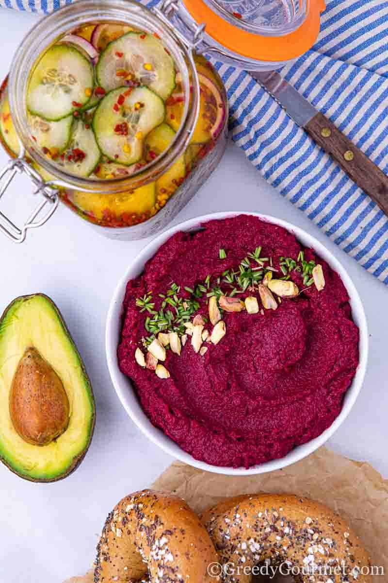 Bowl of a purple roasted beet recipe with an avocado