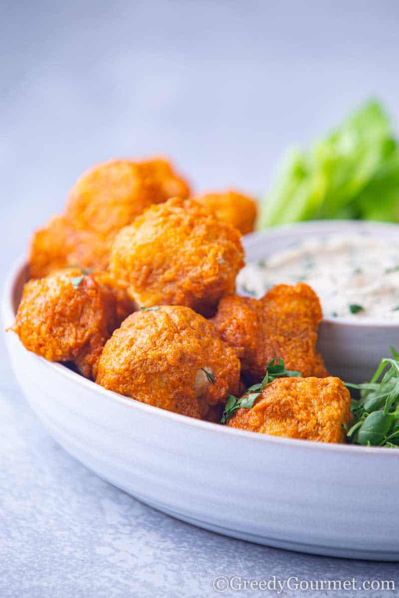 Bowl of orange buffalo cauliflower wings